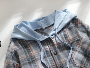 Detail of plaid hooded shirt featuring blue grey red pattern and light blue drawstring hood