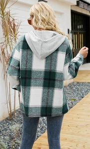 Outdoor back view of a green plaid hooded shacket with relaxed fit for autumn