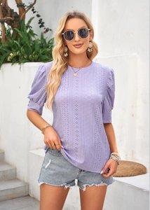 Close-up of light purple eyelet embroidery top with short puff sleeves and round neck