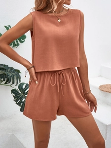 Detailed texture of sleeveless top and drawstring shorts in terracotta linen fabric