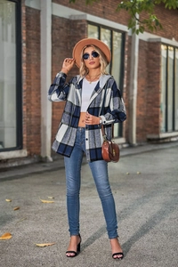 Detailed macro view of the blue and white plaid flannel texture and grey knit drawstring hood