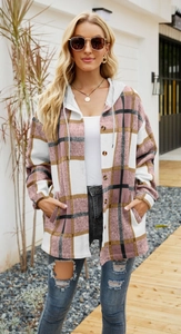 Detail of pink plaid hooded shacket featuring tortoiseshell buttons and side pockets