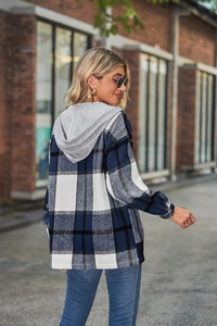 Close-up of a blue and white plaid hooded shirt jacket with a grey knit hood for autumn