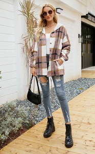 Close-up of pink and brown plaid hooded shacket with distressed blue skinny jeans