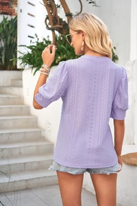 Detail of lavender eyelet hollow-out fabric and puff sleeves on summer casual top