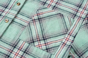 Close-up detail of mint green plaid flannel shirt showing breast pocket and buttons