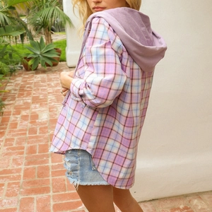 Macro view of pastel plaid hooded shirt jacket featuring a purple hood and curved hemline