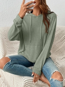 Detail of sage green ribbed knit hoodie featuring drawstring hood and kangaroo pocket