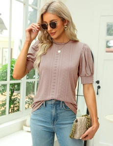 Detail of pink knit top featuring vertical hollow dot texture and puff short sleeves