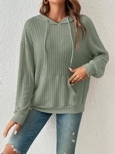 Close-up of sage green ribbed knit hoodie featuring drawstring hood and kangaroo pocket