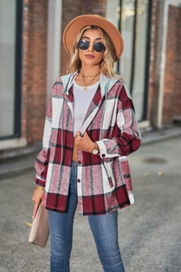 Detail shot of a red and white plaid hooded flannel shacket with oversized buttons