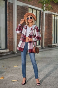 Classic red plaid hooded shacket styled with blue jeans in a street fashion setting
