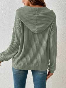 Rear view of women's sage green ribbed knit hoodie showing textured fabric and dropped shoulders