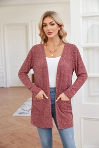 Close-up of ribbed knit texture on a mauve long-sleeve cardigan with button details