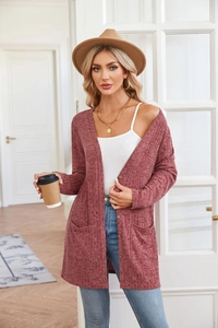 Detail view of long-sleeve knit cardigan with ribbed texture and front pockets