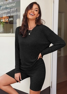 Detail of black ribbed knit two-piece set featuring long-sleeve top and cycling shorts