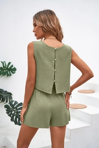Back view of sage green linen two-piece set featuring a button-down sleeveless top and shorts