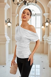 Detail of silver sequin one-shoulder top with elegant ruching for party wear