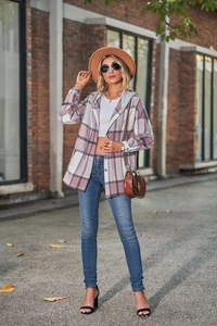 Detail of pink plaid hooded shirt jacket with buttons and drawstring on street model