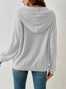 Back view of a light gray ribbed knit hoodie with dropped shoulders and a large hood