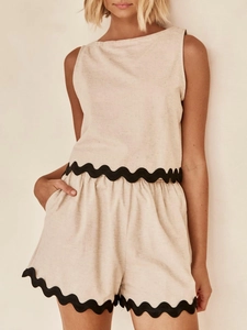 Detail of beige linen two-piece set with black scalloped lace trim and elastic waist