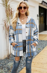 Detail of blue and orange plaid hooded shacket showing button closure and side pockets