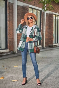 Detail of green and white plaid hooded jacket with button closure and brushed texture