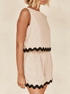 Detail of linen sleeveless top and shorts set with black rickrack wave trim edges