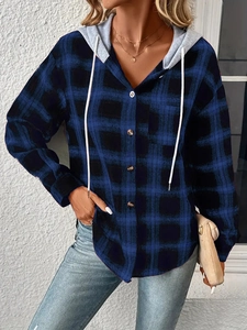 Detail of blue plaid hooded shirt featuring brown buttons and adjustable grey hood