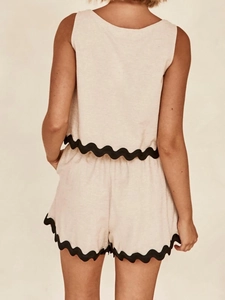 Rear view of two-piece linen set featuring sleeveless top and shorts with black scallop trim