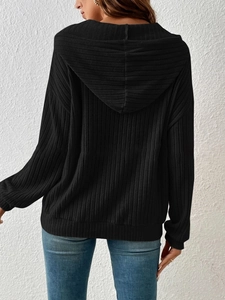 Detailed back view of a black ribbed knit hoodie featuring a hood and drop shoulders