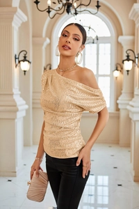 Detail of champagne gold sequined one-shoulder top with elegant side pleats for women