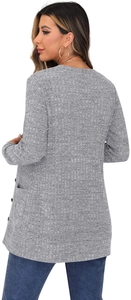 Detail of grey waffle-knit cardigan showing side pocket texture and button accents