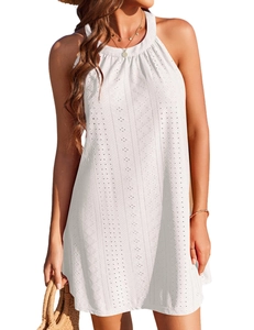 Close-up of white halter neck dress featuring intricate floral eyelet embroidery details