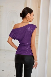 Detail of purple one-shoulder sequin top with ruched texture for party wear