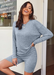 Detail of light blue-grey rib-knit set showing long sleeve top and cycling shorts texture
