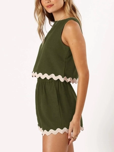 Detail view of the scalloped pink lace hem on olive green two-piece linen summer set