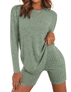 Detail of sage green ribbed knit texture on the long sleeve top and slim shorts set