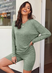 Detail of light green knitted lounge set showing soft fabric texture and sleeve drape