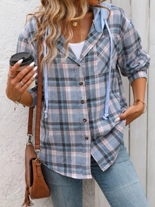 Detailed close-up of a plaid hooded shirt with drawstring and button-down front closure