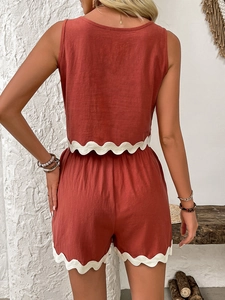 Detailed back view of rust red linen two-piece set featuring delicate white scallop lace trim