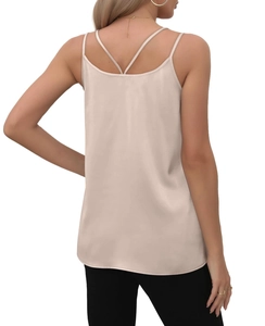 Detail of champagne satin camisole showing cross-back thin straps and glossy texture