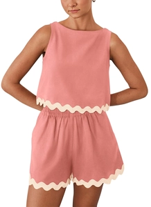 Detailed close-up of coral pink two-piece set featuring elegant white scalloped edges