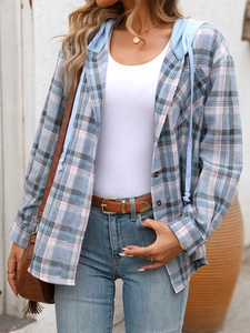 Detail of blue and grey oversized hooded plaid shirt with chest pockets and drawstrings