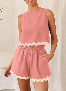 Detail of mauve two-piece linen set showing lace scallop trim on top hem and shorts