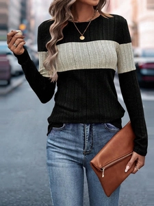 Detail of slim-fit ribbed knit sweater featuring black and grey color-block patchwork design
