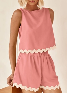 Detailed view of pink linen set with delicate white scalloped lace trim on shorts and top