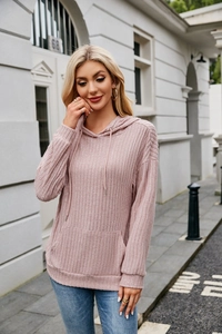 Close-up of pink ribbed knit hoodie showing kangaroo pocket and texture detail