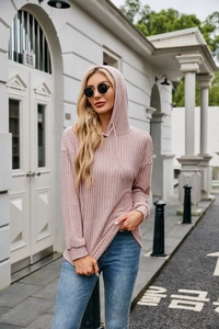 Close-up detail of pink ribbed knit texture on a stylish women's drawstring hoodie