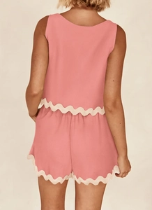 Rear view of pink two-piece set featuring delicate scalloped lace edges on top and shorts